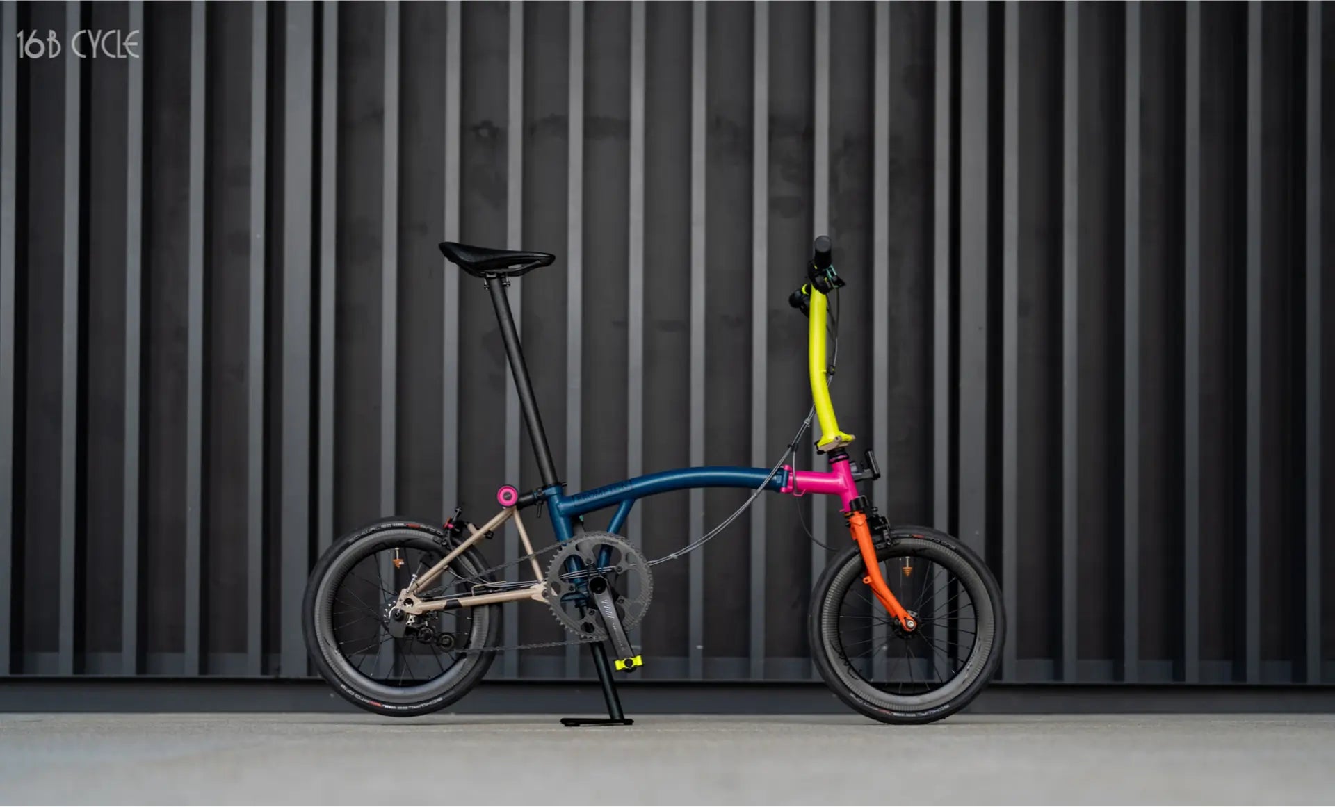 Custom colorful Brompton bicycle by 16B Cycle with vibrant frame and wheels, set against a modern black background
